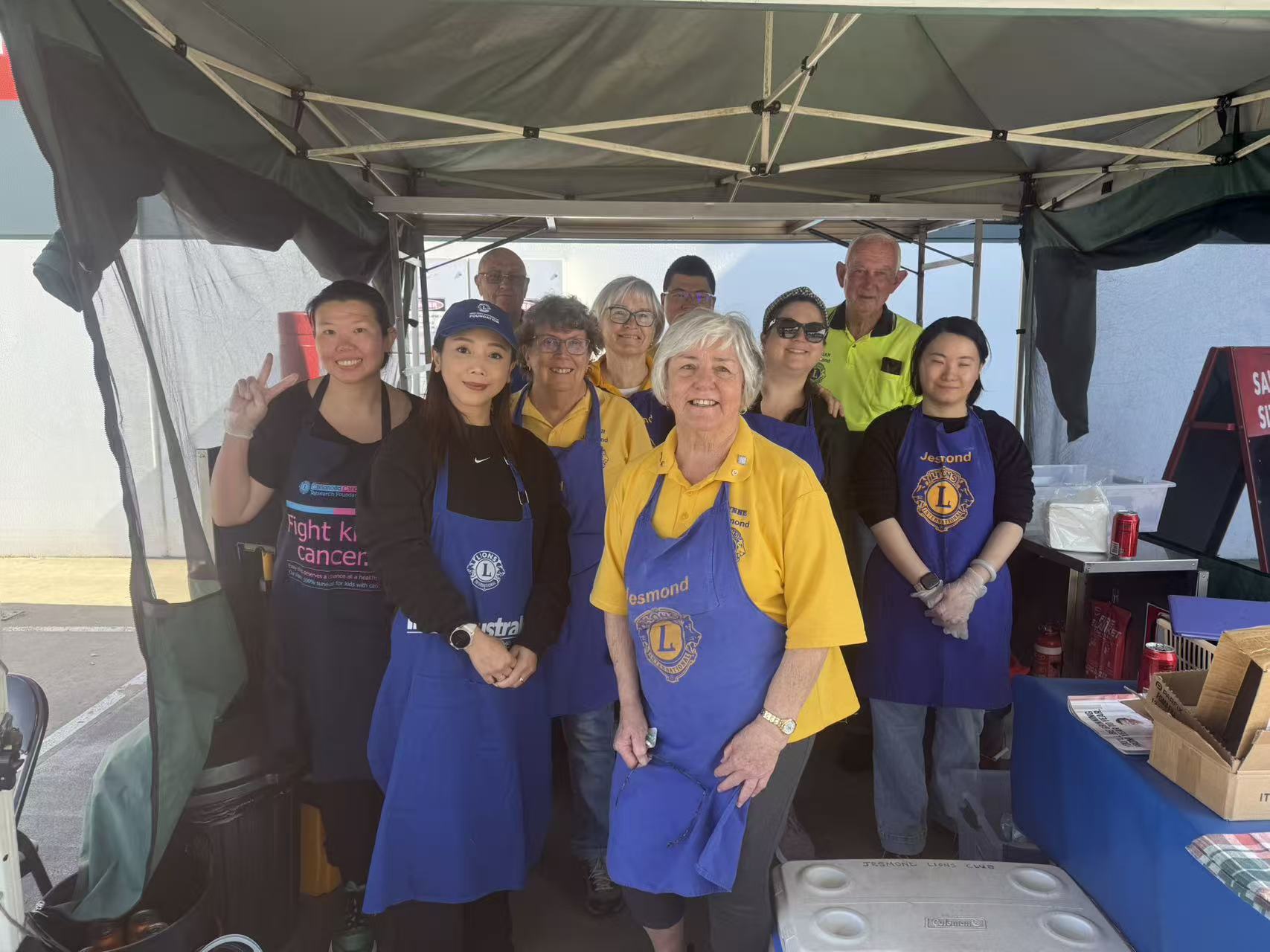 Volunteers taking part in a Bunnings community BBQ