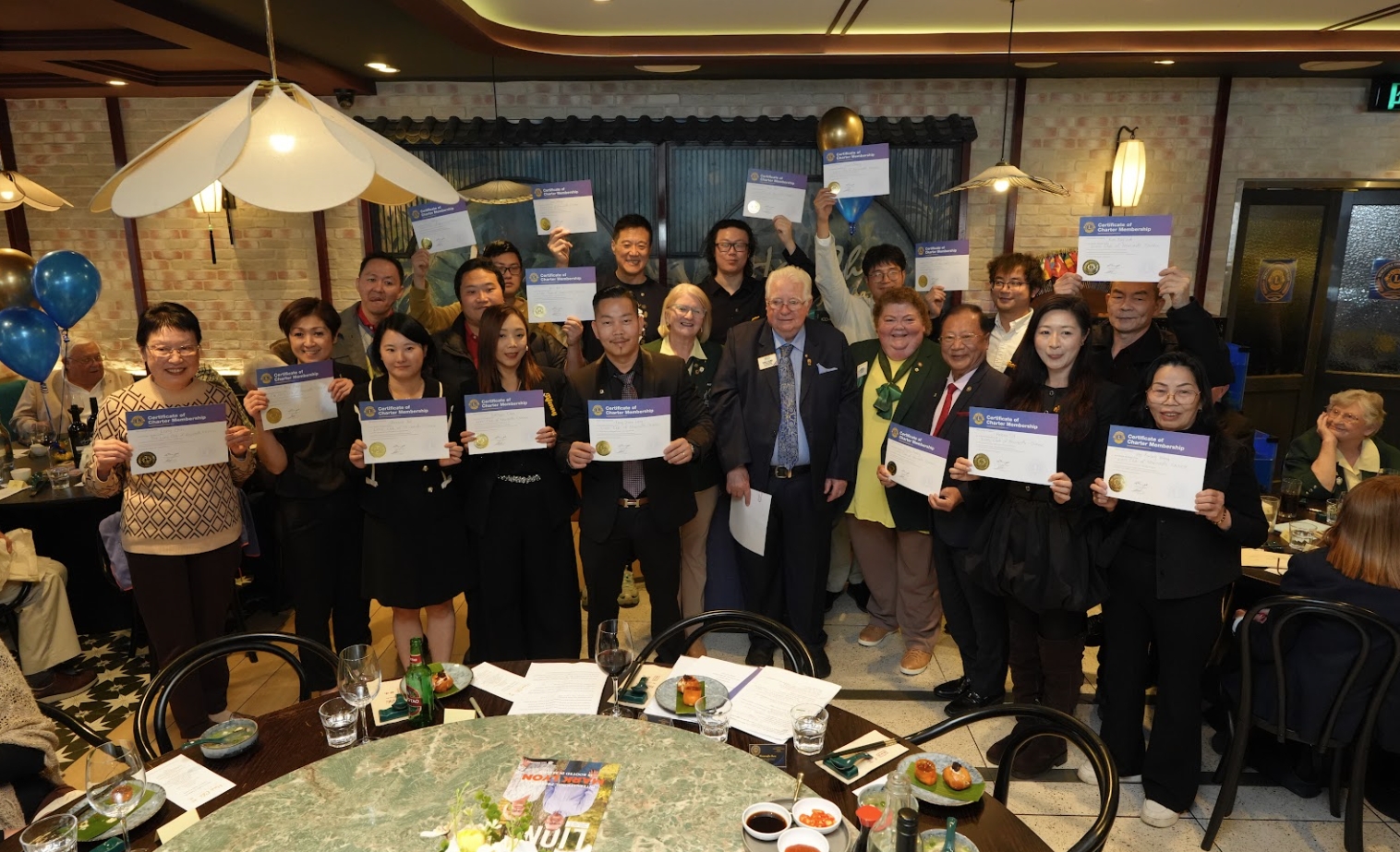 Charter members receiving certificates at the Newcastle Chinese Lions Club launch celebration